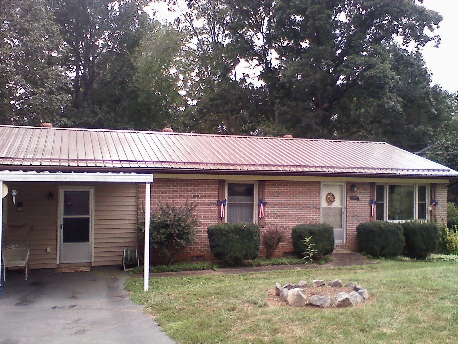 Bronze metal roof and carport on a brick ranch home — Roof Repair work by our crew in Ventura